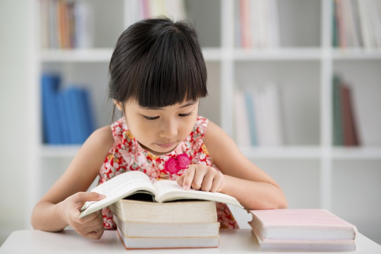 https://www.mindchamps.org/wp-content/uploads/2020/03/Asian-child-studying-with-books.jpg